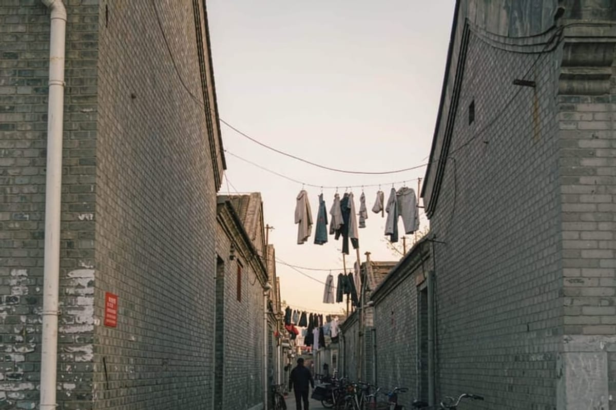 Beco de hutong ao amanhecer com luz baixa